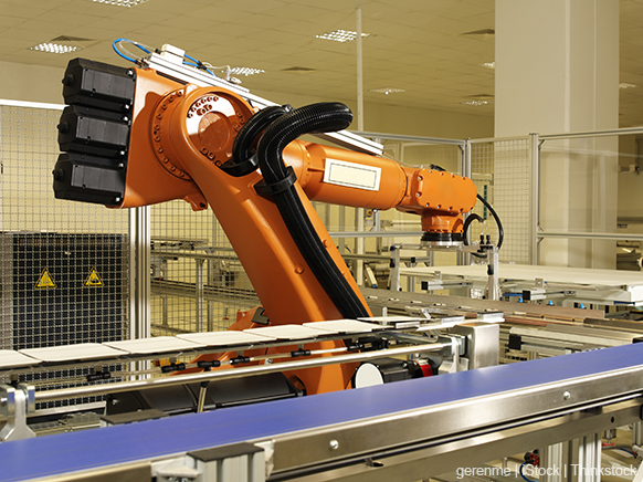 A photo shows a large robotic arm working on a factory assembly line