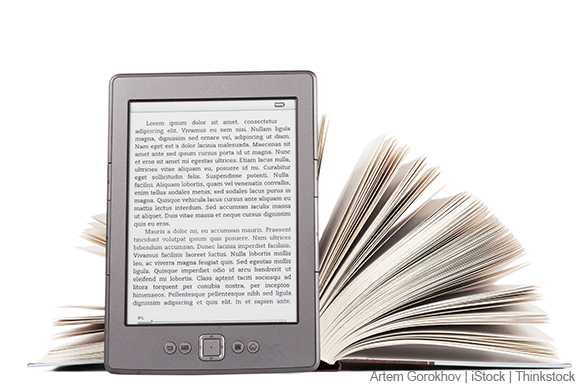 A photo shows an e-reader leaning against an open book