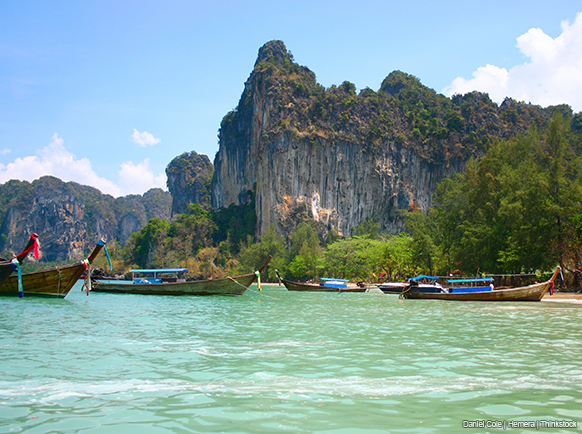 A photo shows a Thai fishing boats moored just off shore